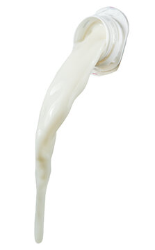 Thick stream of white milk pouring from bottle bottle-neck isolated on a white background. Clipping Path.