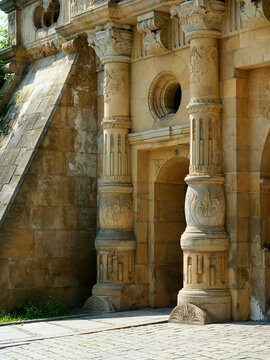 Richly ornamented portal of Legnica Piast Castle with decorated columns and reliefs. Sunlight emphasizes the sculpted stonework.