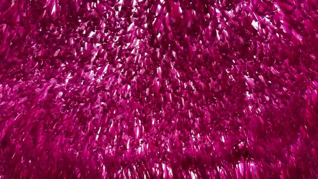 Slow motion footage of hanging pink ribbons swaying in the wind