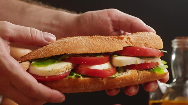 Sandwich with tomato and mozzarella, Italian style caprese baguette with fresh arugula, vegetarian bocadillo close up for cafe breakfast menu