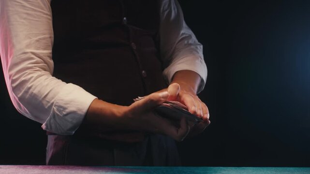 Magic trick, Professional croupier shuffling and dealing playing cards at a casino table, poker and blackjack game, magician performing a card trick shuffling cards deck