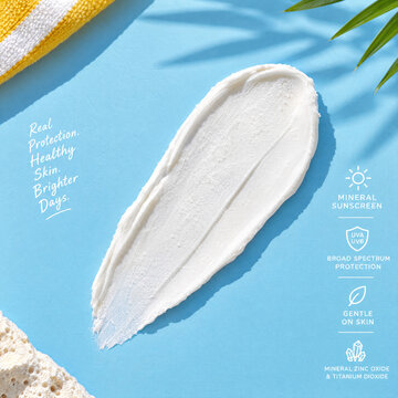 Mineral sunscreen texture smear on blue background with summer skincare  