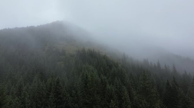 Aerial view of Dolina Juraniowa, Bobrowiecka Przełęcz, and Jamborowy Wierch shrouded in mist and clouds in summer, Western Tatras
