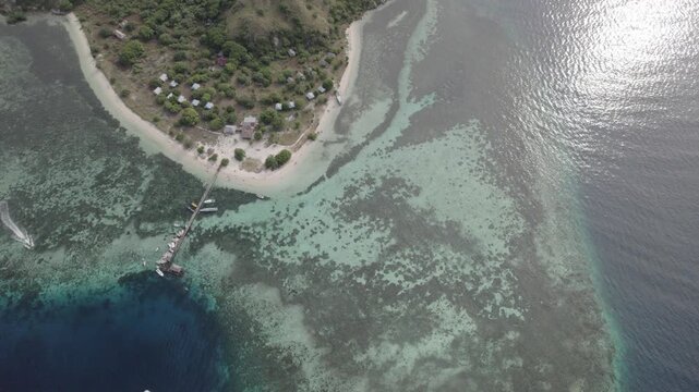 Aerial Drone Video of Kanawa Island Resort with Pier and Coral Reef in Turquoise Ocean