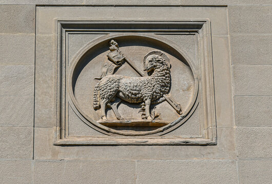 Historic Agnus Dei stone relief on the Chamber of Commerce building facade in Florence, Tuscany, Italy