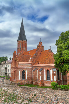 Apse view of the Church of Vytautas the Great in Kaunas, Lithuania. Gothic brick architecture under a partly cloudy sky