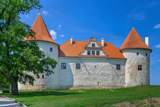 View of the restored towers of Bauska Castle in Latvia. Renaissance and medieval architecture under a clear blue sky