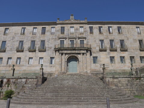 View of the historic stone facade of the Convento e Igrexa de San Francisco, featuring a grand staircase, arched entrance, and symmetrical windows in Pontevedra, Pontevedra, Spain.