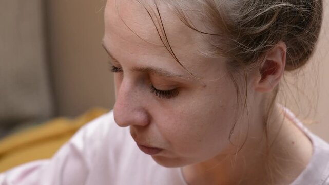 Close-up footage of a woman finishing a serving of miso soup and eating a boiled egg with a spoon. 