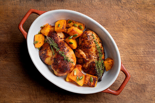 Autumn meal: roasted chicken breast and pumpkin with herbs