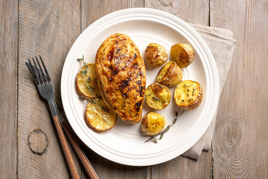 Oven roasted lemon garlic chicken and potatoes on plate