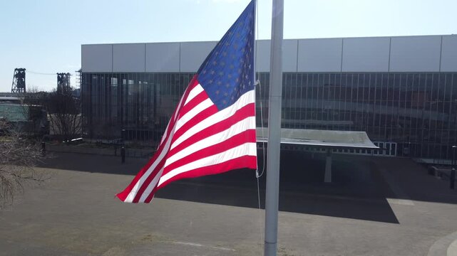 American flag waving on a flagpole against blue sky