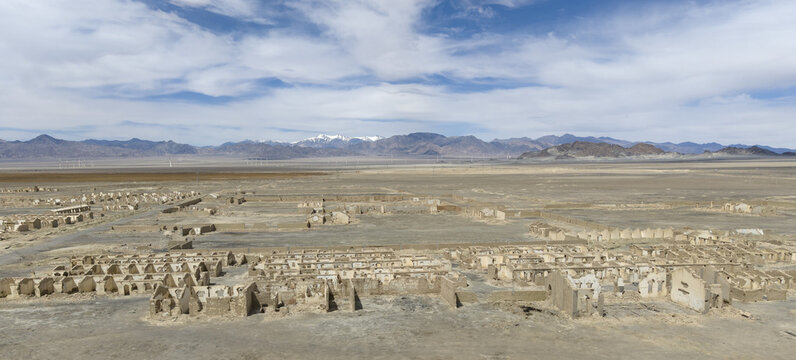 Ancient ruins of Bam Citadel in Iran with snowy mountains in the background