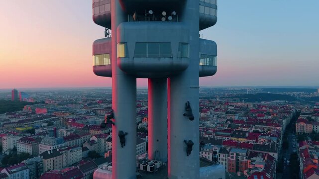 Aerial view of Zizkov Television Tower with its iconic crawling baby sculptures, overlooking the cityscape of Prague, Hlavni mesto Praha, Czechia.