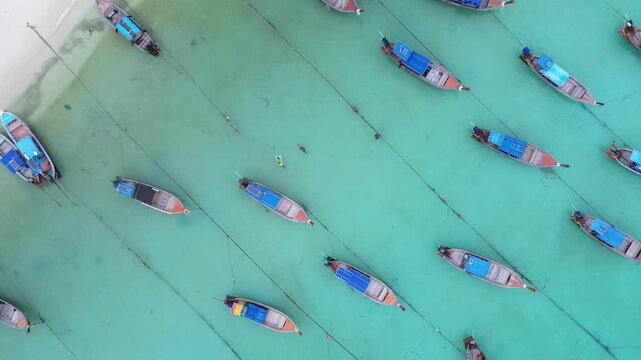 Traditional thai longtail boats anchored in turquoise sea