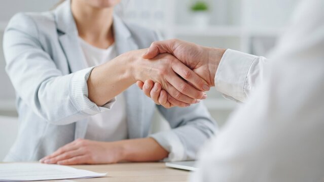 Business people shaking hands in an office setting