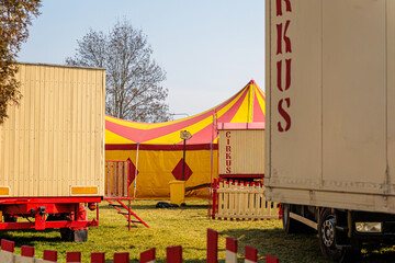 Empty Traveling Circus Site With Colorful Red And Yellow Tent And Service Trailers © Olga