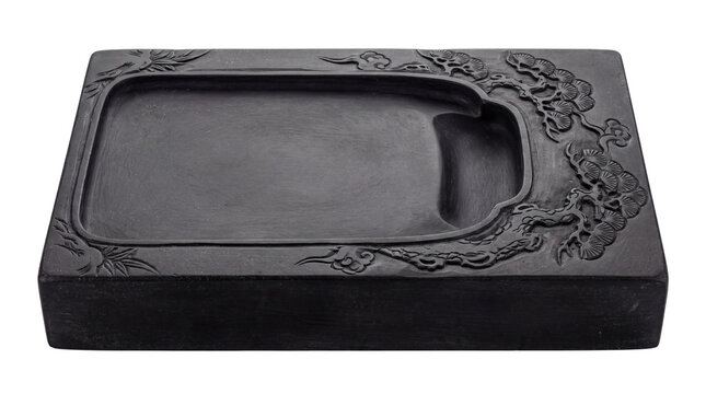 Traditional Chinese inkstone with carved pine motifs, dark grey stone slab for calligraphy, oriental ink grinding stone tool isolated PNG with Transparent Background