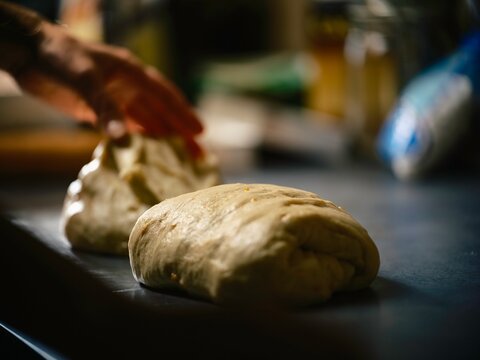 Christmas baking cozonac preparation with dough being shaped on a kitchen countertop highlighting cultural heritage in the Balkan region rich in traditions and authenticity
