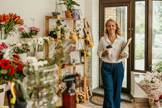Smiling florist small business owner working in flower shop