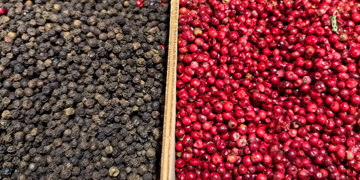 Vivid black and red peppercorns create a colorful spice display