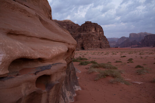 Dramatic sandstone rock formations and red sand in Wadi Rum desert Jordan