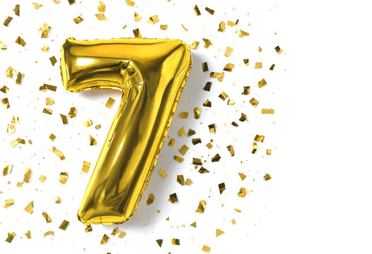 Golden number seven balloon with confetti celebration decoration isolated