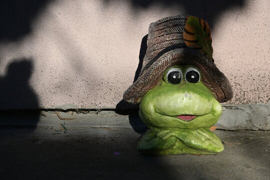 Decorative frog statue in an outdoor garden setting