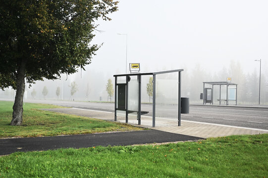 A quiet Finnish bus stop on a foggy autumn morning