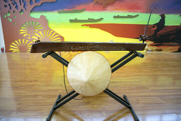 Traditional Vietnamese Musical Instrument Display with Conical Hat in Museum © TranPhuoc