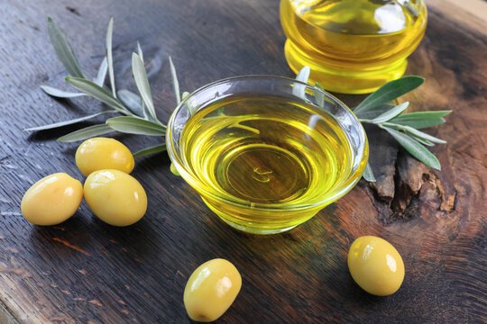organic olive oil and olives in a glass bowl	
