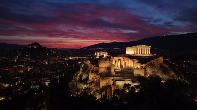 Night aerial view of illuminated Acropolis in Athens, capital of Greece at night, drone shot of Acropolis hill and the Parthenon at night, travel in Greece