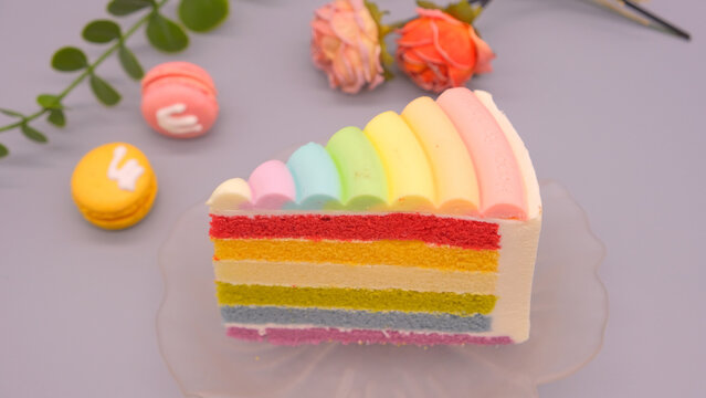 Pastel Rainbow Layer Cake Slice with Macarons and Roses