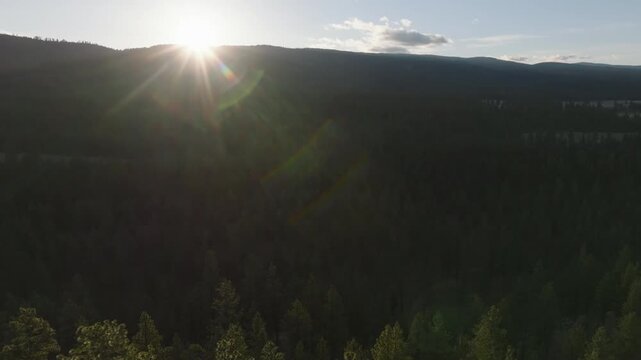 Aerial sunrise over forested mountains in Montana