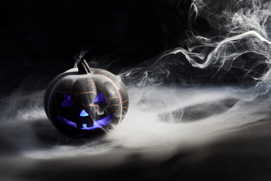 Halloween jack-o'-lantern glowing purple with mystic smoke