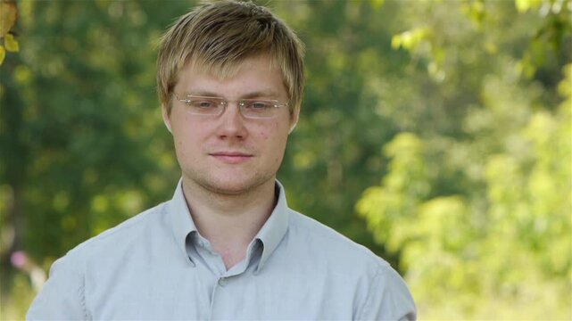 student (male) with glasses reading book