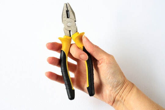 Insulated Pliers Held in Hand for Electrical Installation and Safety Work. Electrician Service Concept