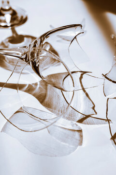 Broken Wine Glass Shards with Dramatic Shadows and Light Reflections