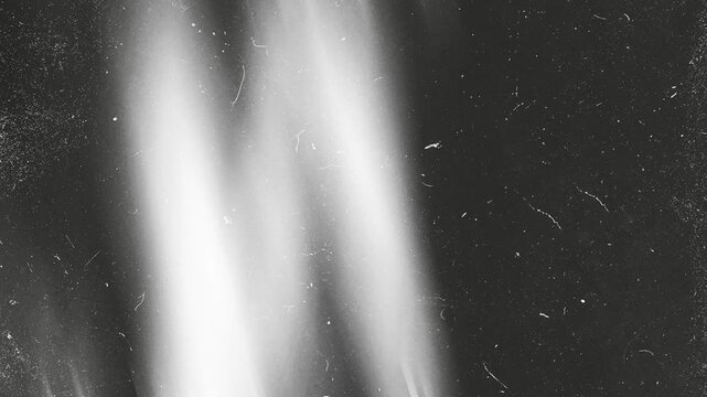 Animated light leak overlay with film grain, dust, Noise, Grunge scratches and vintage cinematic Retro texture. Abstract 4K motion background loop for video editing, filmmaking and creative overlays.
