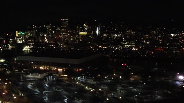 Night aerial view of downtown Portland with illuminated skyline and arena