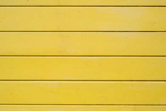 Bright yellow painted horizontal wooden boards texture