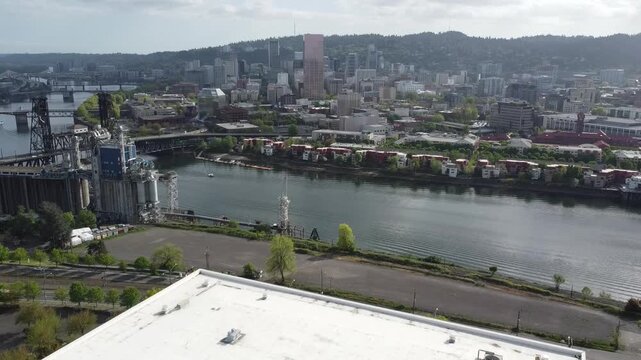 Daytime aerial view of the Portland skyline along the Willamette River with bridges