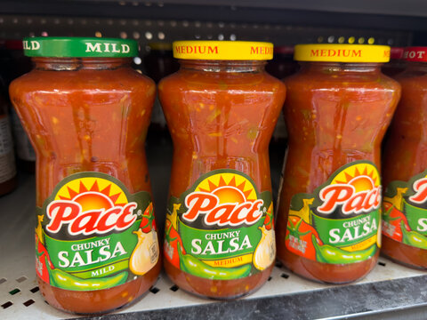 Frisco, Texas, USA - September 14th, 2026: Pace chunky salsa glass jars sitting on shelf inside retail grocery store displaying mild and medium spice levels