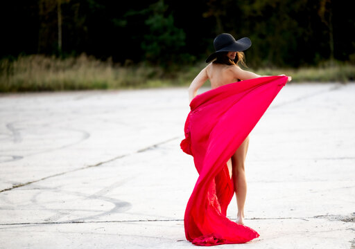 Dance of Freedom in Nature with a Red Cloak and a Graceful Elegant Figure