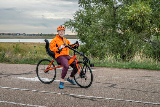 senior cyclist with a road recumbent bike on a parking lot in Boyd Lake State Park, Colorado