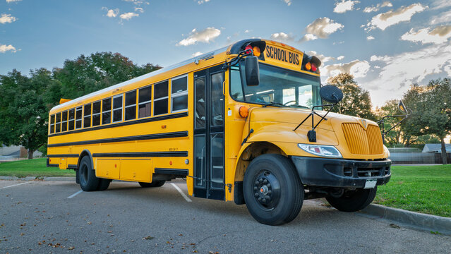 yellow school bis on a parking lot in early morning