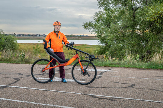 senior cyclist with a road recumbent bike on a parking lot in Boyd Lake State Park, Colorado