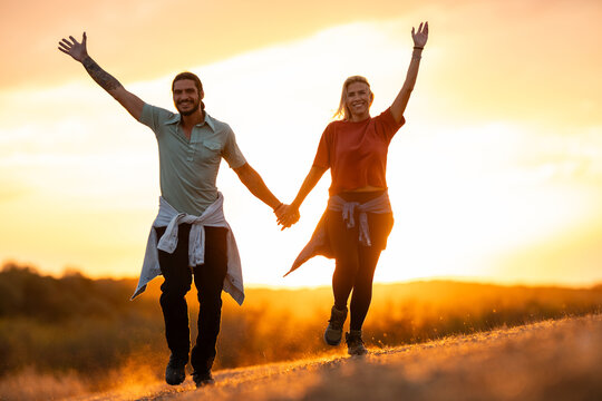 Happy couple enjoying outdoor adventure at sunset