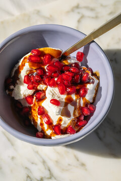 greek yogurt bowl with pomegranate and pomegranate molasses 