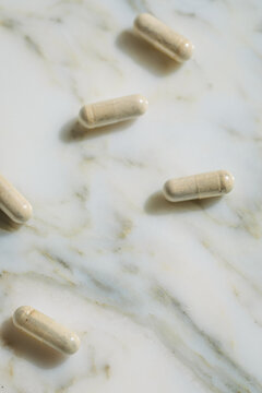 iron supplement capsules on white marble